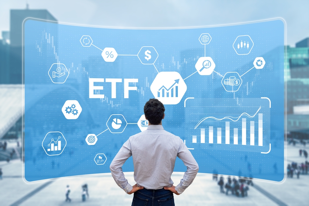 man looking at board that says ETF