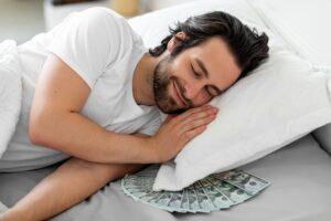 man sleeping on pile of money