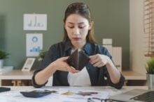 woman looking in wallet