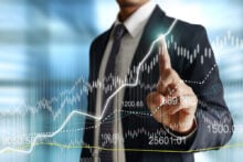 Businessman,With,Financial,Symbols,Coming