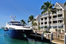 Luxurious yacht docked in front of condos