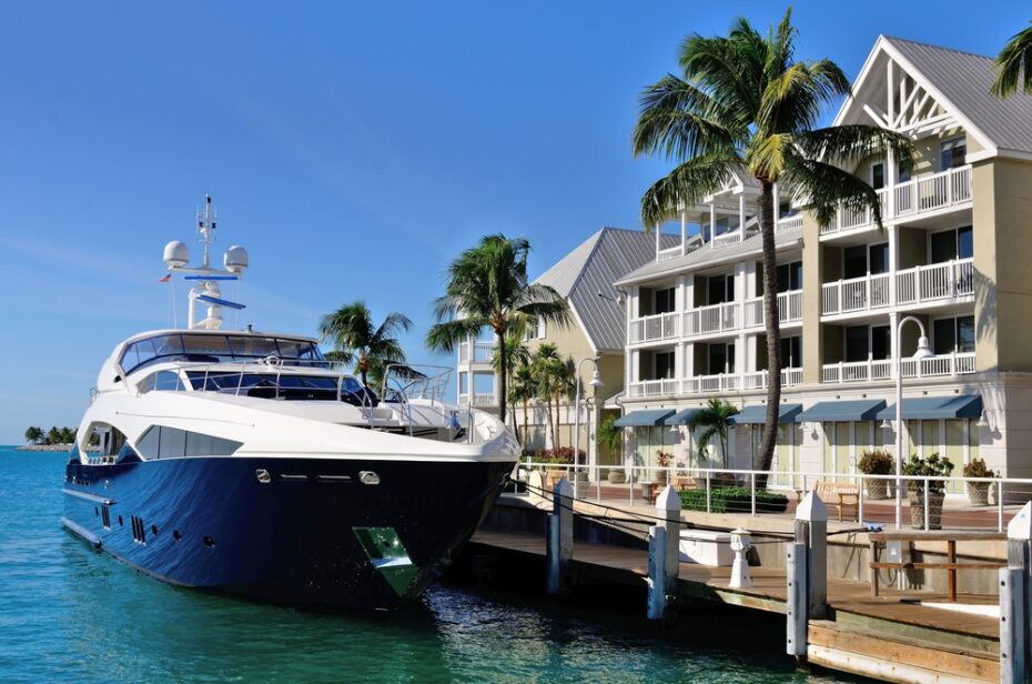 Luxurious yacht docked in front of condos