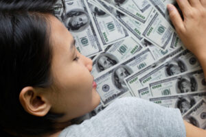 woman sleeping on money