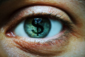 Close up of a person with a dollar sign in their eye
