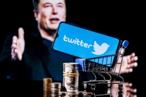 Elon Musk pictured with Twitter logo and stack of money