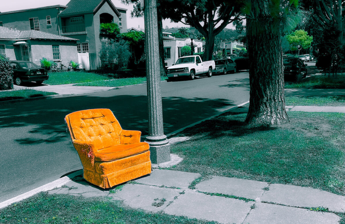 Old recliner on a street curb