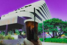 Office worker holding ice coffee outside an office