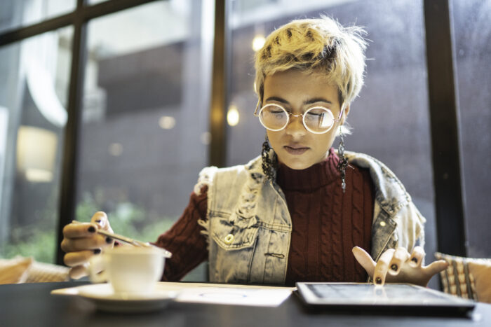 Latin woman checking some graphics from digital investment