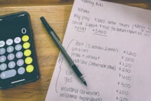 Single mom budget with calculator and pen
