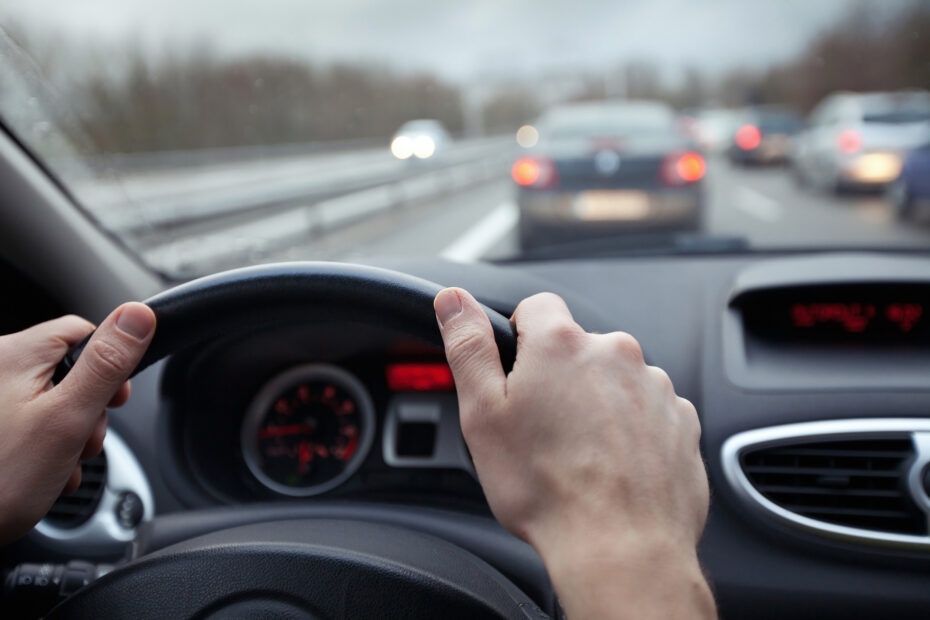 First person point of view of driving a car in traffic