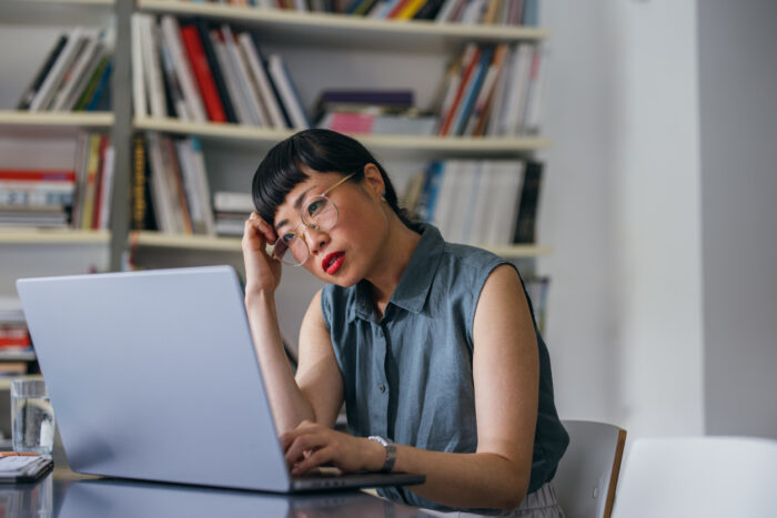 Frustrated woman sitting at a computer