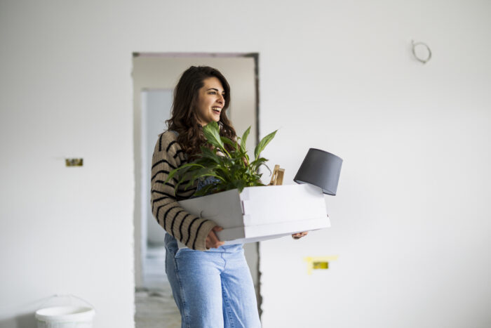 Portrait of young woman in her new apartment