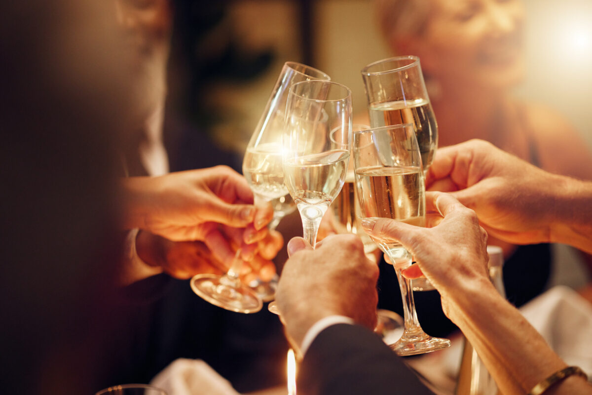 Close shot of multiple people doing clinking their drinks together