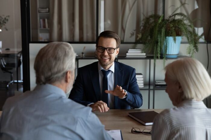 Happy confident lawyer giving consultation to a couple