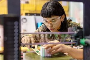 Woman using a 3d printer