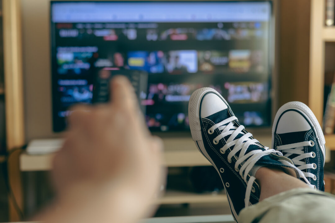 Relaxed Person At Home Watching TV