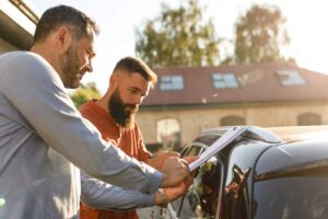 Man selling a car to another man