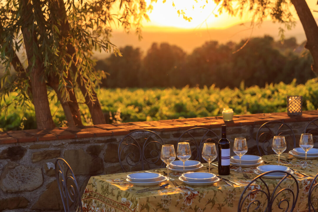 Outdoor table with vineyard background in susnet time in tuscany italy