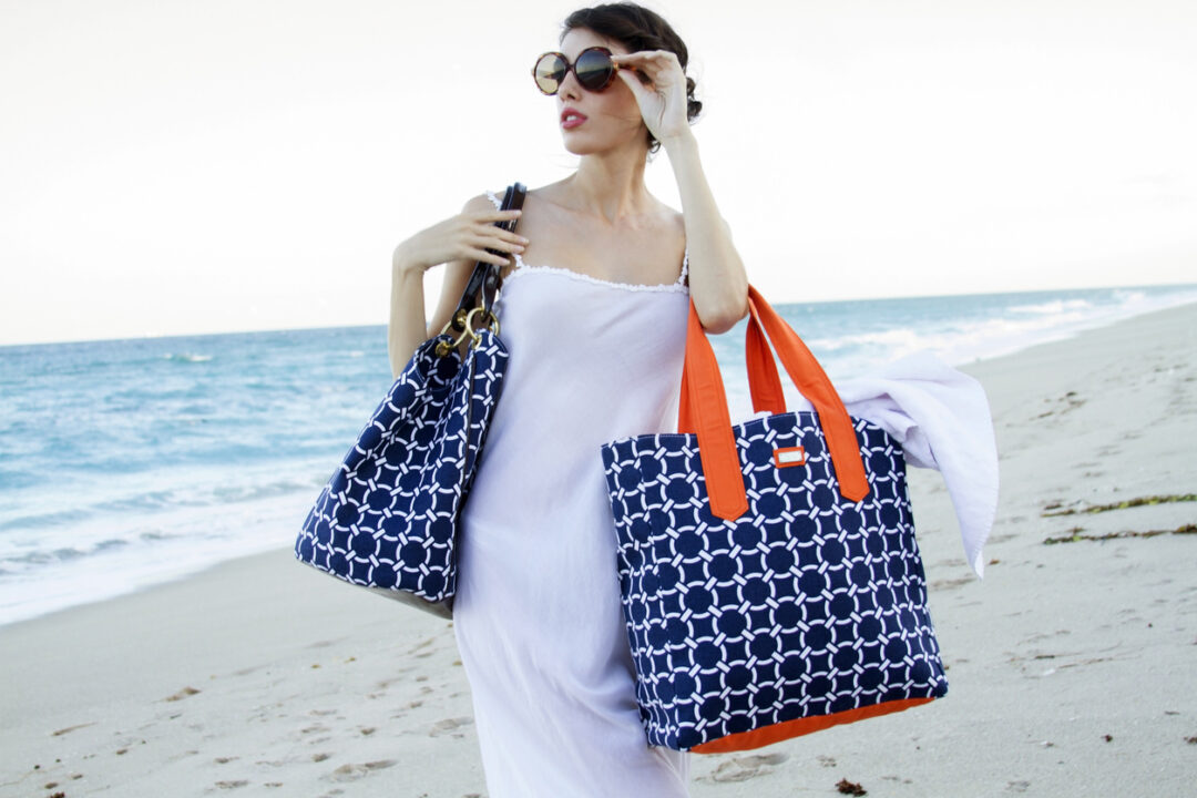 Beautiful woman on beach with sunglasses and fashionable bags on beach - still looking for the golf ball i crushed earlier that day. lol.