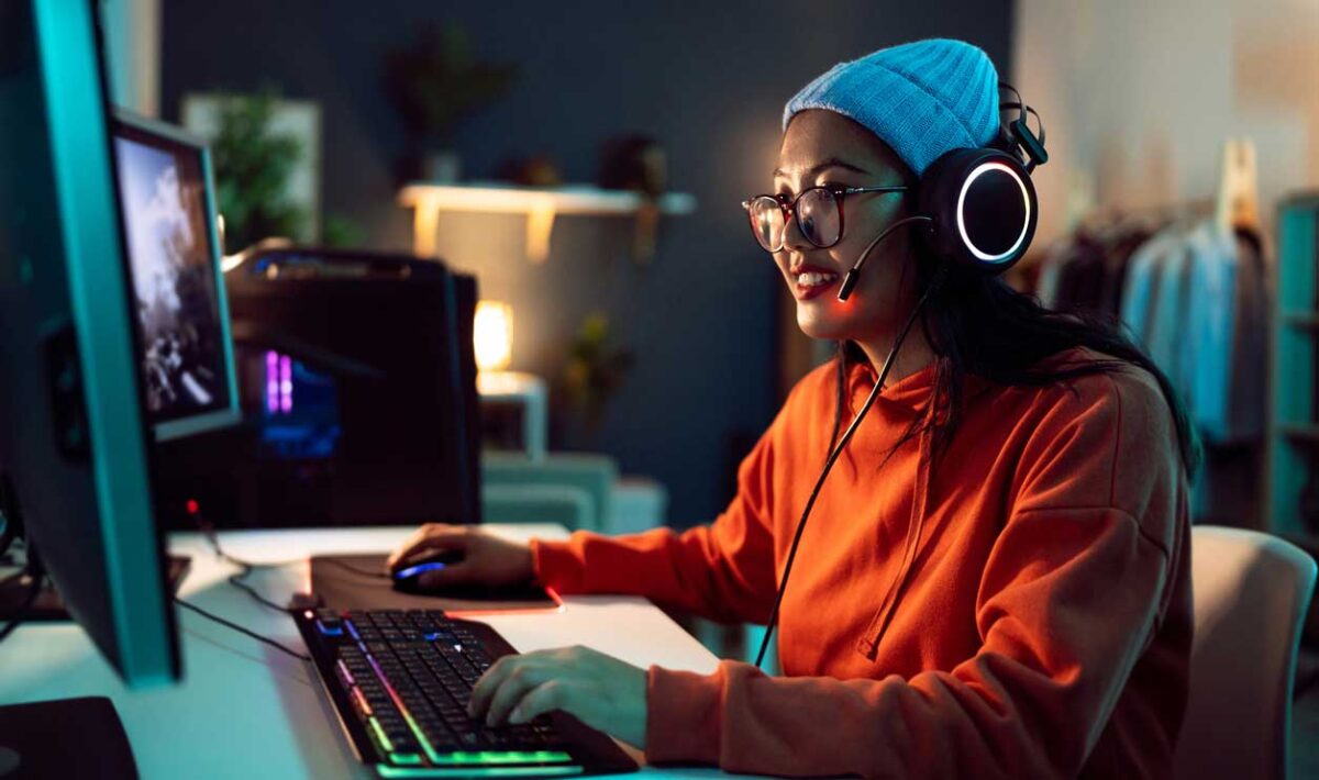 Woman playing video games on her PC