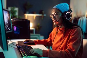 Woman playing video games on her PC