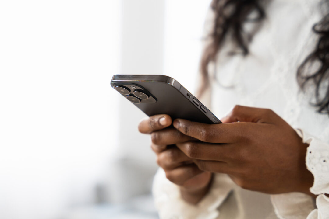 Closeup of hands using phone. Unrecognisable black person using phone with copy space