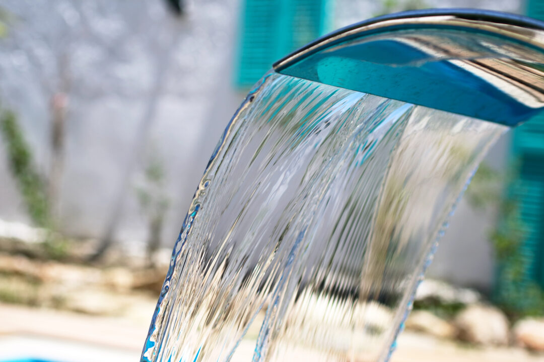 Pouring water in the swimming pool