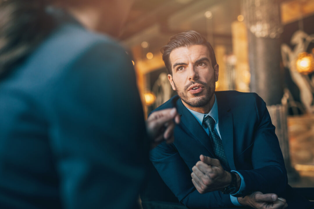 Portrait of a confident businessman in a meeting.