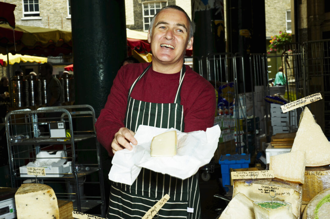 Portrait of man selling fresh cheese