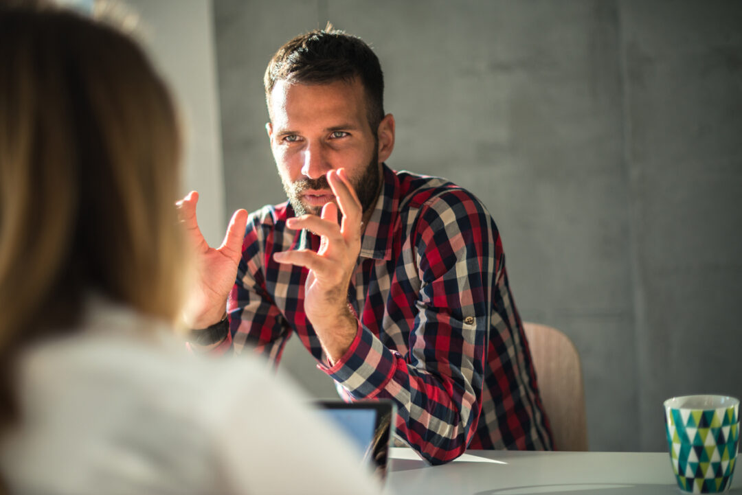 Man explaining ideas to his female colleague.