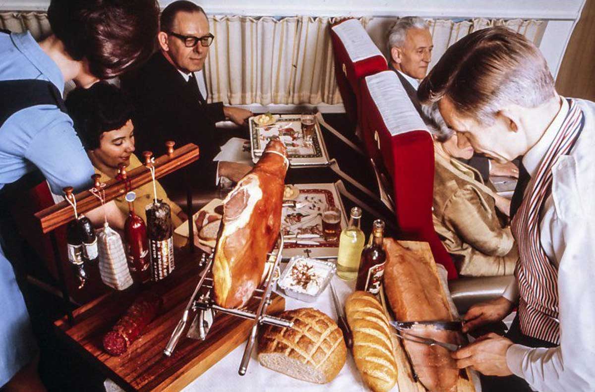 Passengers getting a delicious meal on a flight in the 1970s