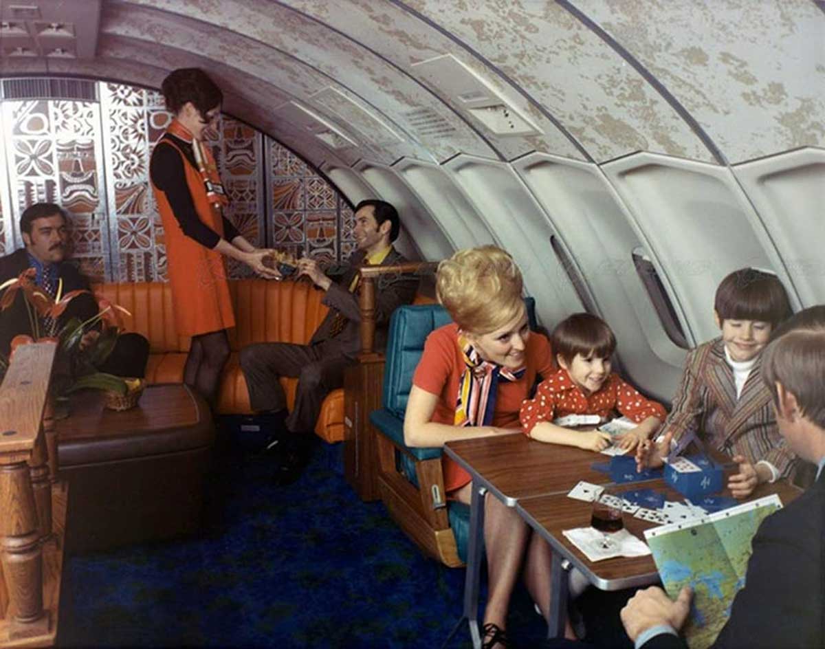 Family playing cards on a luxury flight in the 1970s