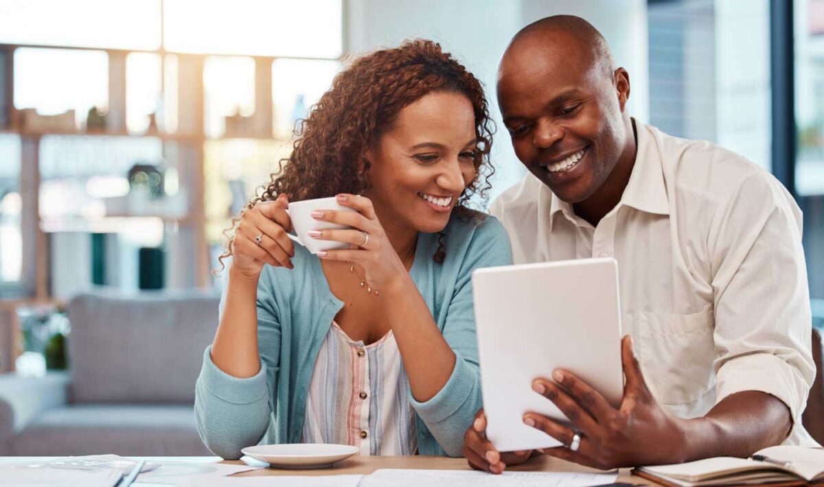 Couple looking at a tablet in their home