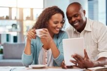 Couple looking at a tablet in their home