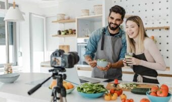 Couple cooking in front of a camera