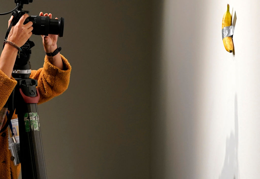 Italian visual artist Maurizio Cattelan's duct-taped Banana entitled "Comedian," is photographed during a press preview at Sotheby's in New York, on October 25, 2024. The viral artwork was unveiled in 2019, and one of the artwork's three "editions" is going back on sale on November 20, 2024, and is estimated by Sotheby's to sell for between $1m and $1.5m. (Photo by TIMOTHY A. CLARY / AFP) / RESTRICTED TO EDITORIAL USE - MANDATORY MENTION OF THE ARTIST UPON PUBLICATION - TO ILLUSTRATE THE EVENT AS SPECIFIED IN THE CAPTION (Photo by TIMOTHY A. CLARY/AFP via Getty Images)