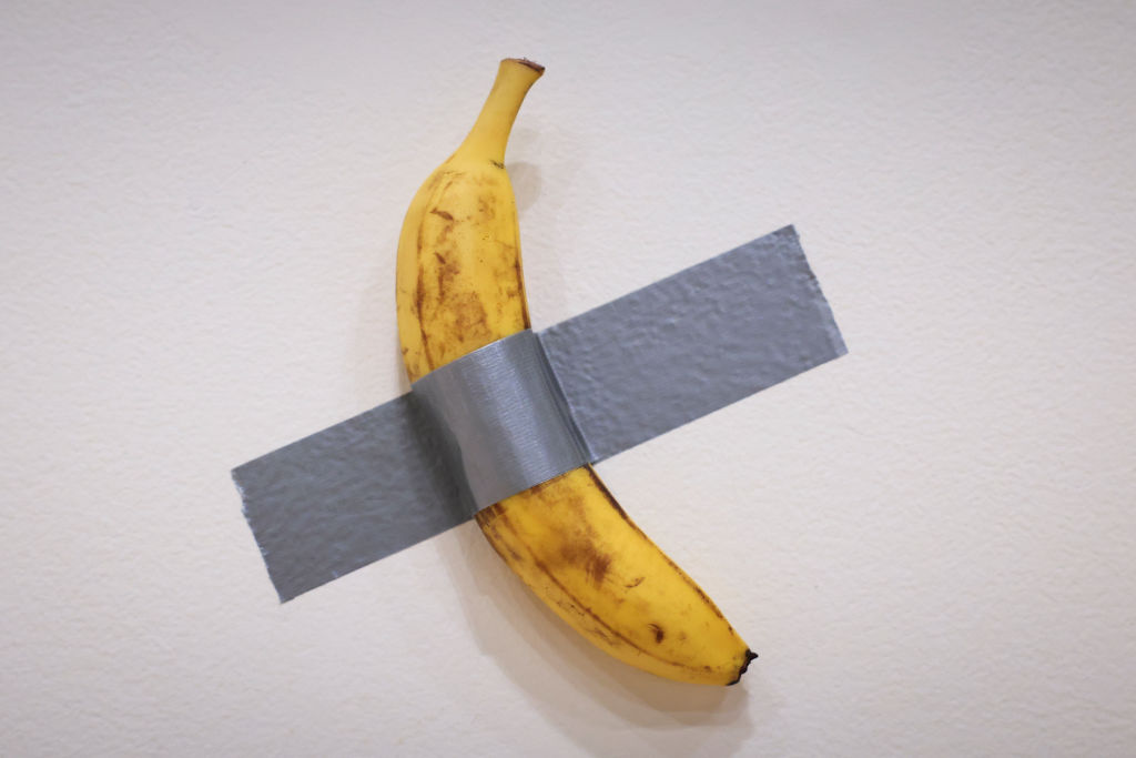 Italian visual artist Maurizio Cattelan's duct-taped Banana entitled "Comedian," is on display during a media preview at Sotheby's in New York, on November 8, 2024. A work by Belgian painter René Magritte, another by American Ed Ruscha and a vulgar banana are the stars that could set records for their authors in the art auctions that begin this week in New York in a market that hopes to overcome last year's slump.
