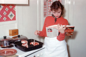 Young woman in the kitchen, ca. 1956.