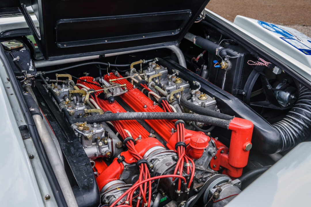 Baden-Baden, Germany - 14 July 2019: red motor of white Lamborghini Countach 1974 sports car which is parked in town center, oldtimer meeting event in the center of Baden-Baden