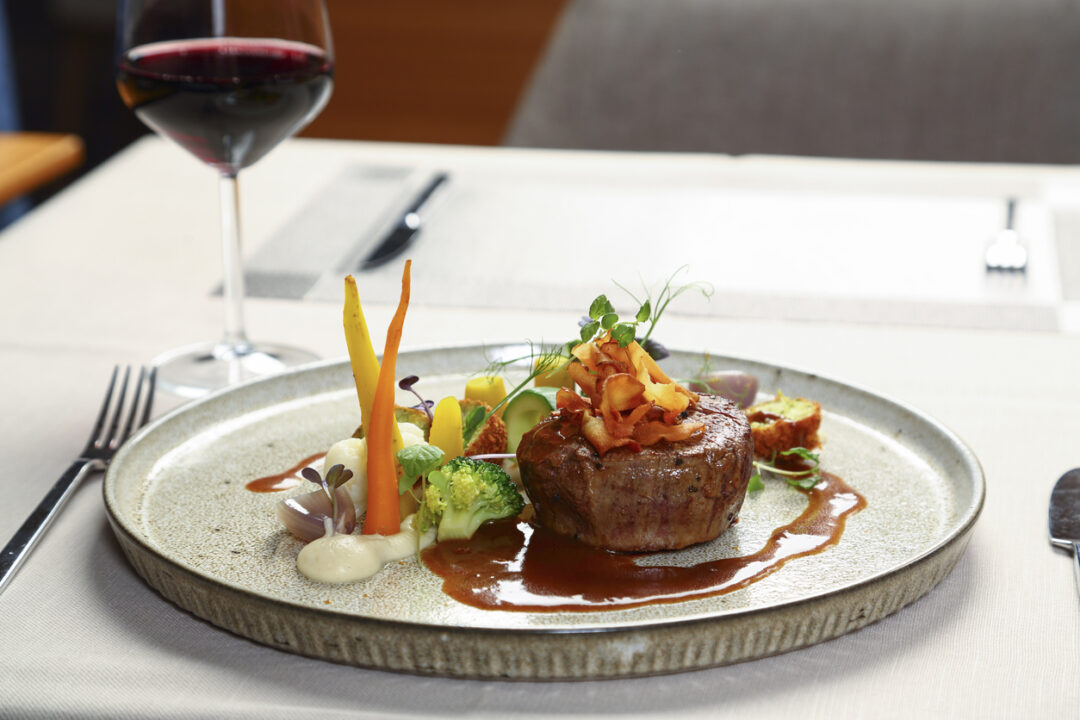 Grilled steak on plate with vegetables