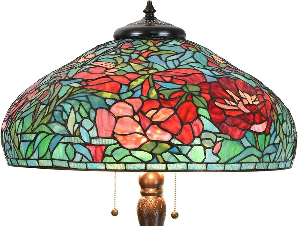 A stained-glass table lamp with a bronze base and a floral-patterned shade reminiscent of expensive Tiffany lamps. The shade features vibrant red, green, and blue colors, depicting roses and leaves. Two pull chains hang from the fixture.