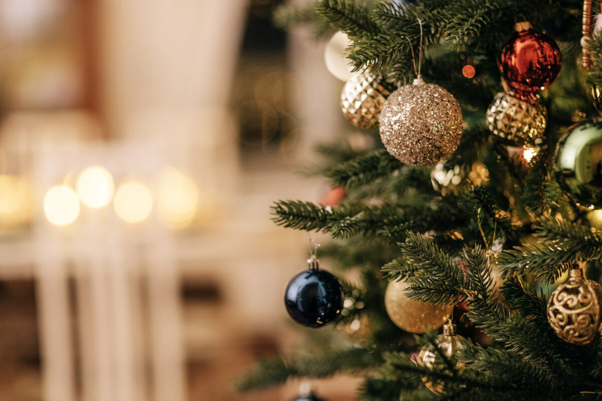 A close-up of a decorated Christmas tree with vintage glass toys.