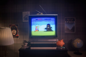 A vintage CRT television displays a retro video game with a character facing a dark figure. The room has a warm lamp, posters on the walls, a globe, and a piggy bank on a shelf, creating a nostalgic ambiance.