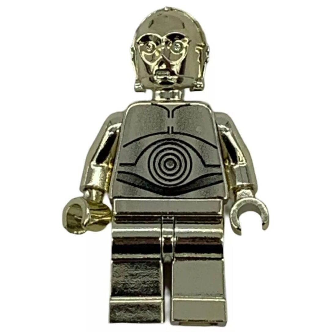 A shiny, metallic silver LEGO figure resembling a robot, featuring intricate details on its torso and head. The figure has a round, segmented pattern on its chest and stands against a plain white background.