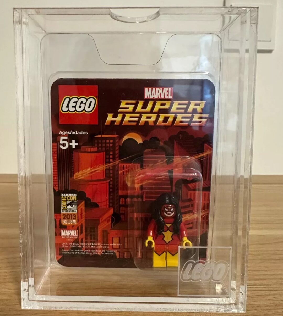 LEGO Marvel Super Heroes collectible minifigure in a clear display case. The packaging features a cityscape background and is labeled for ages 5 and up. The minifigure appears to represent a superhero character.