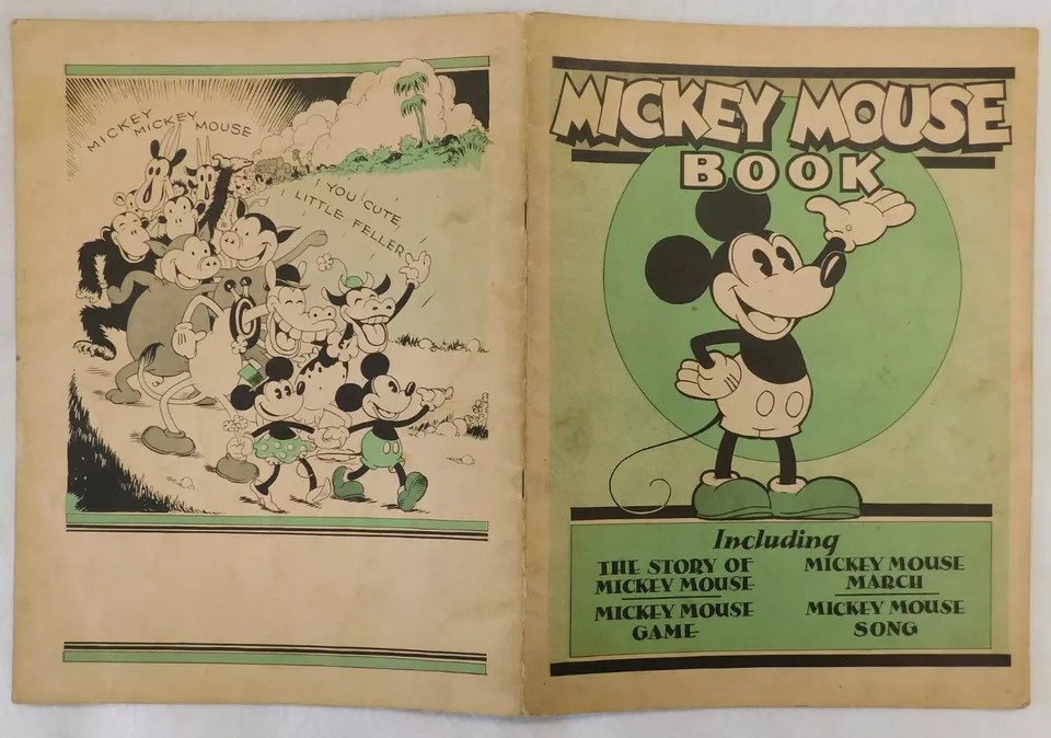 Vintage comic book cover featuring Mickey Mouse. The left page shows Mickey and other characters marching, while the right page lists contents: The Story of Mickey Mouse, Mickey Mouse Game, Mickey Mouse March, and Mickey Mouse Song.