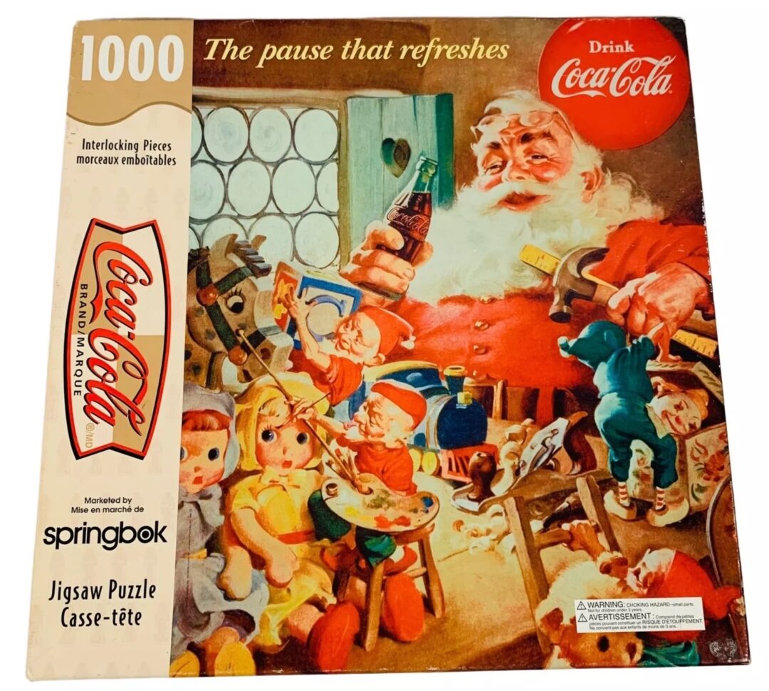 Vintage Coca-Cola puzzle box featuring Santa Claus enjoying a Coke with four children in a festive setting. The box includes the Coca-Cola logo and "The pause that refreshes" slogan. Contains 1000 interlocking pieces.