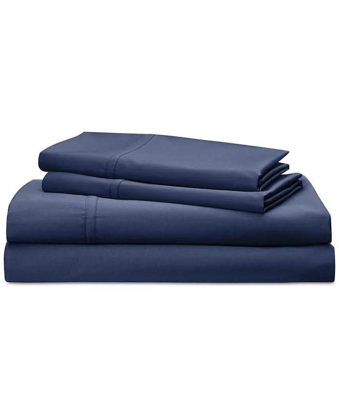 A neatly folded stack of navy blue bedding sheets, including a fitted sheet, a flat sheet, and pillowcases, arranged on a plain white background.