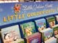 A display stand of Little Golden Books featuring children's books with Christmas themes. The books include titles like "How Do Penguins Play?" and "The Animals' Christmas Eve," with festive illustrations on the covers.