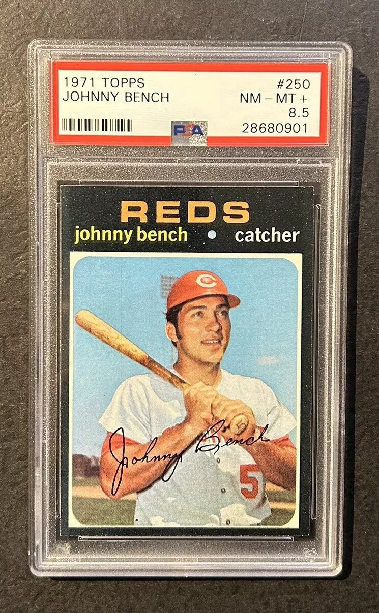 A 1971 Topps Johnny Bench baseball card, graded 8.5, featuring an image of a player in a Reds uniform holding a bat. The card is encased in a protective acrylic holder.